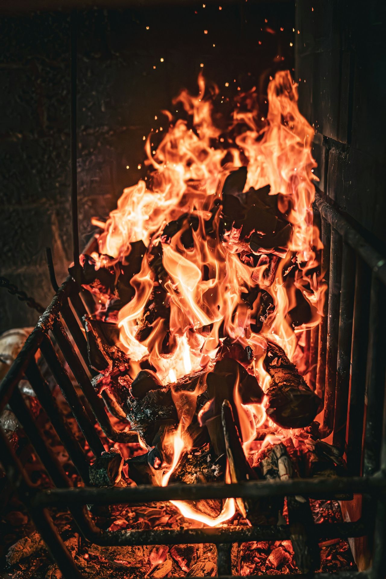 a fire burning in a fireplace with lots of flames