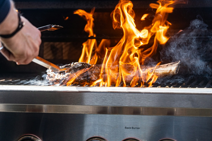 a person cooking food on a grill